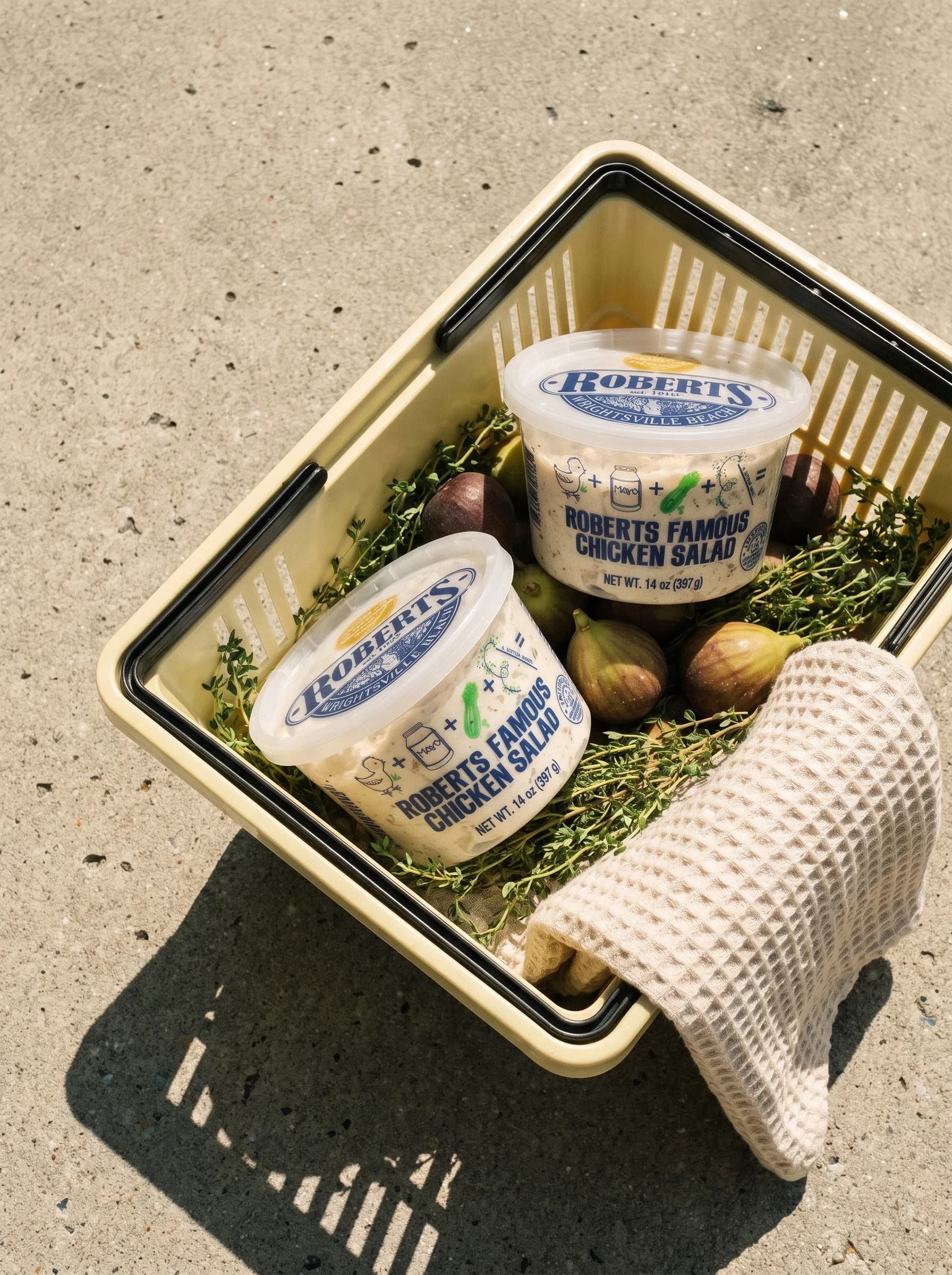 Roberts Famous Chicken Salad tubs packed in a picnic basket in the Carolina sun
